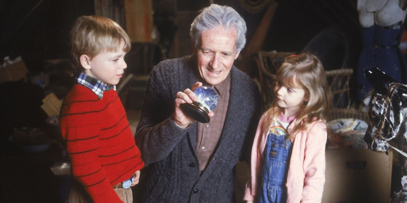 Caleb with a crystal ball and two children in One Magic Christmas